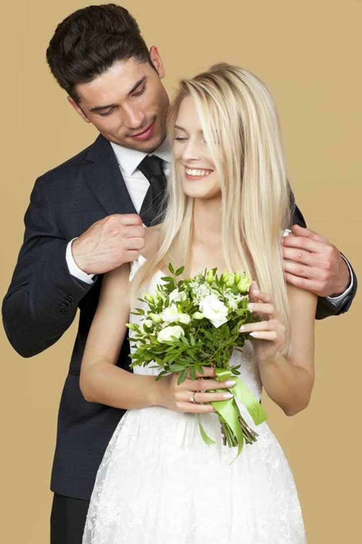 bride and groom holding flowers