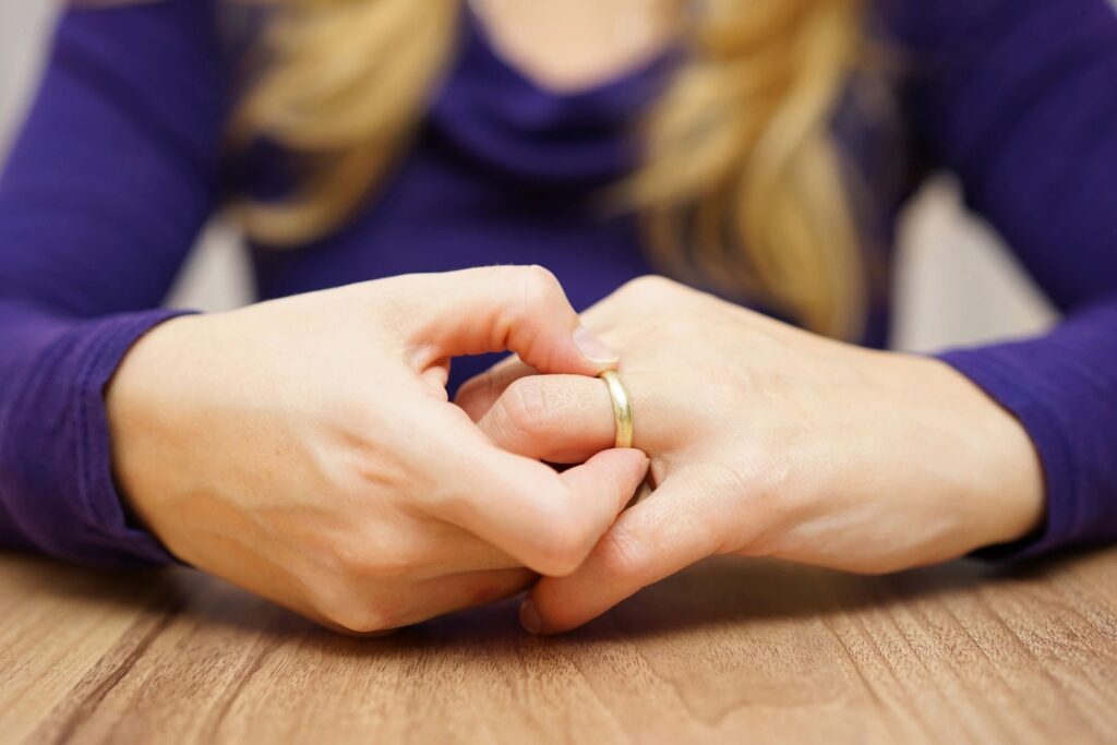 lady taking off wedding ring 