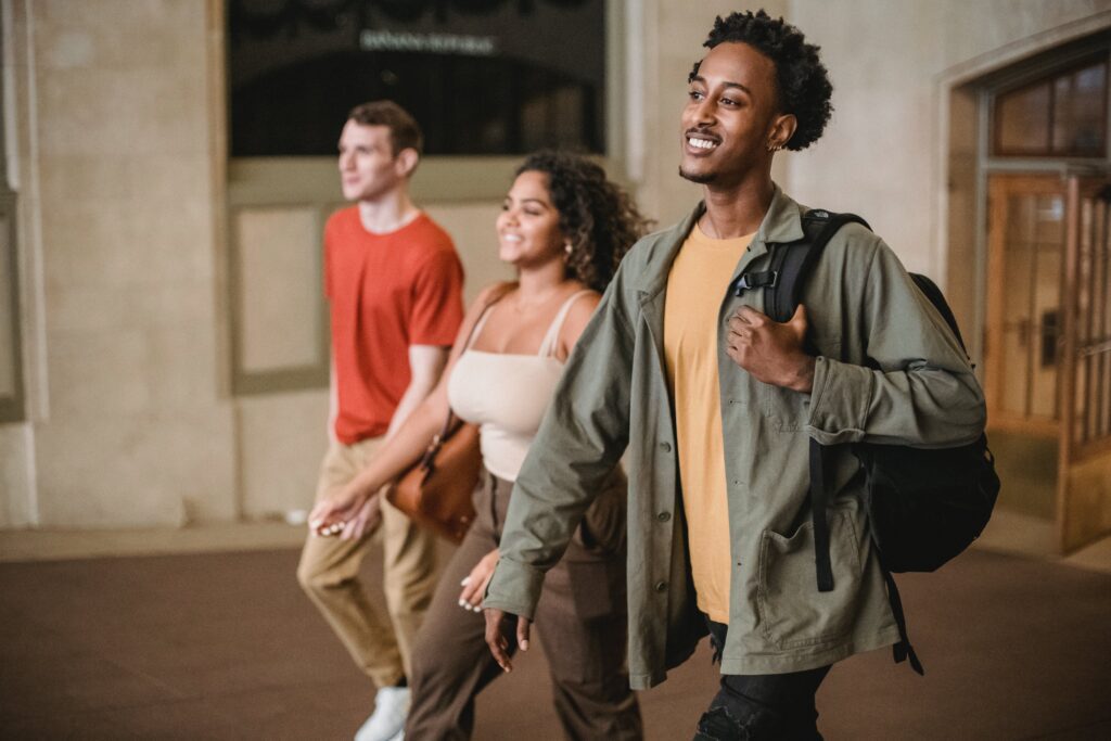 3 teenagers walking in a building