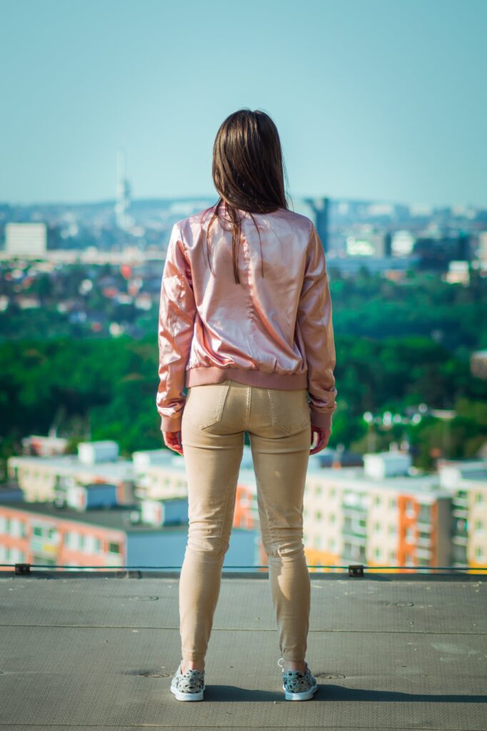 lady standing outside with city in background