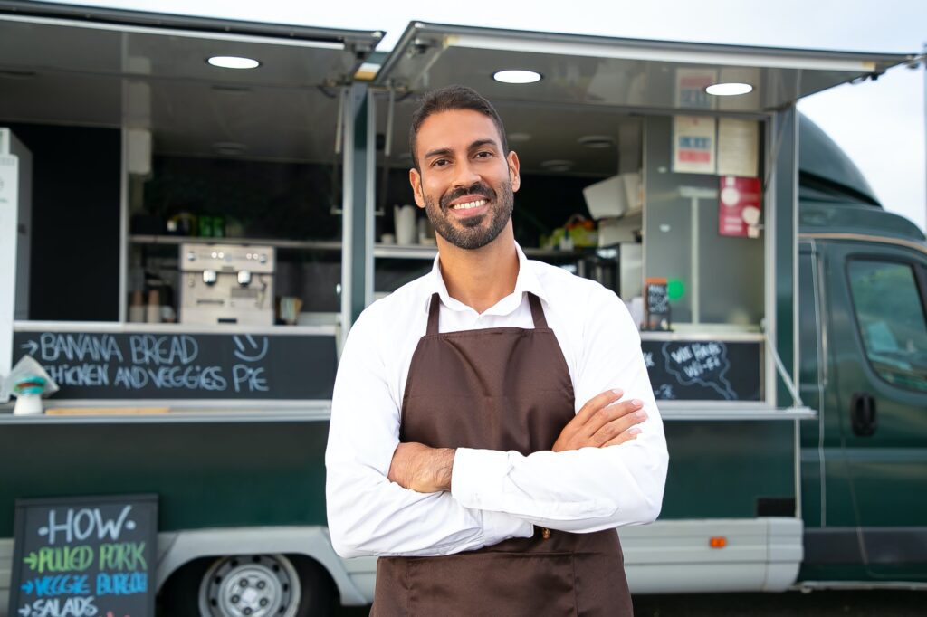 Man standing in front of a food truck 