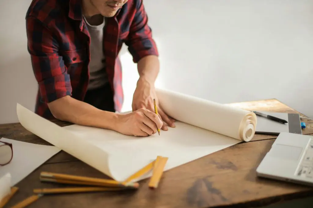 man writing on blank paper 