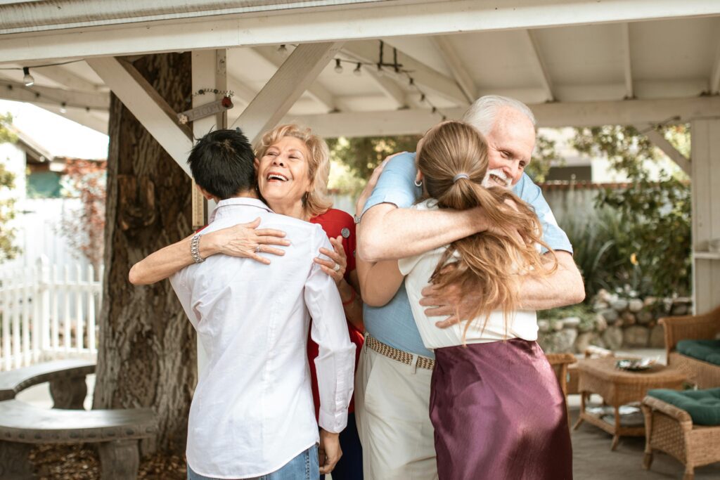 parents hugging their son and daughter