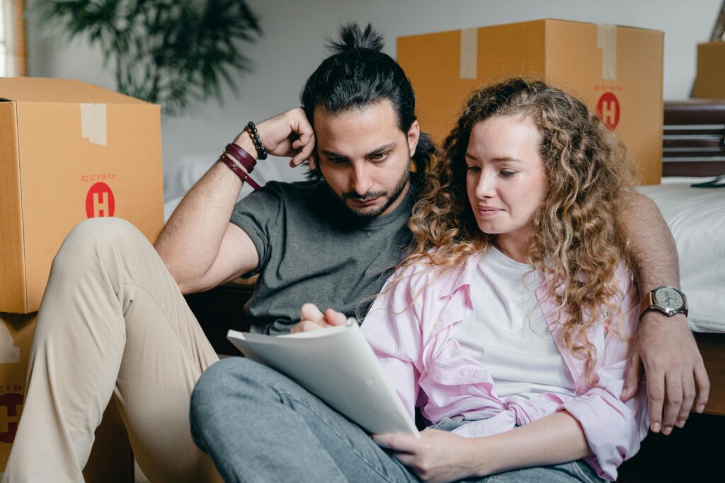 Man and woman looking at papers on a couch
