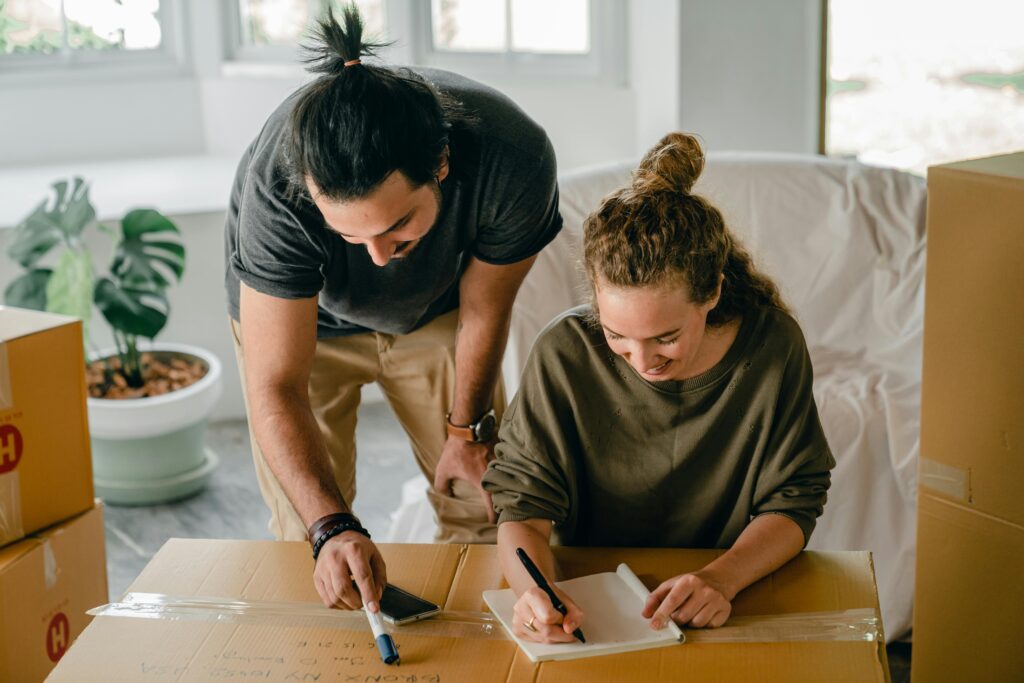 Man and woman looking at papers on a desk 