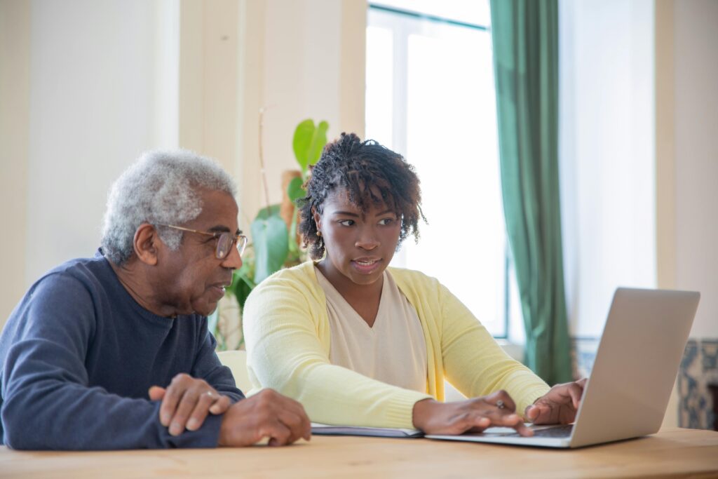 man and lady looking at a laptop 