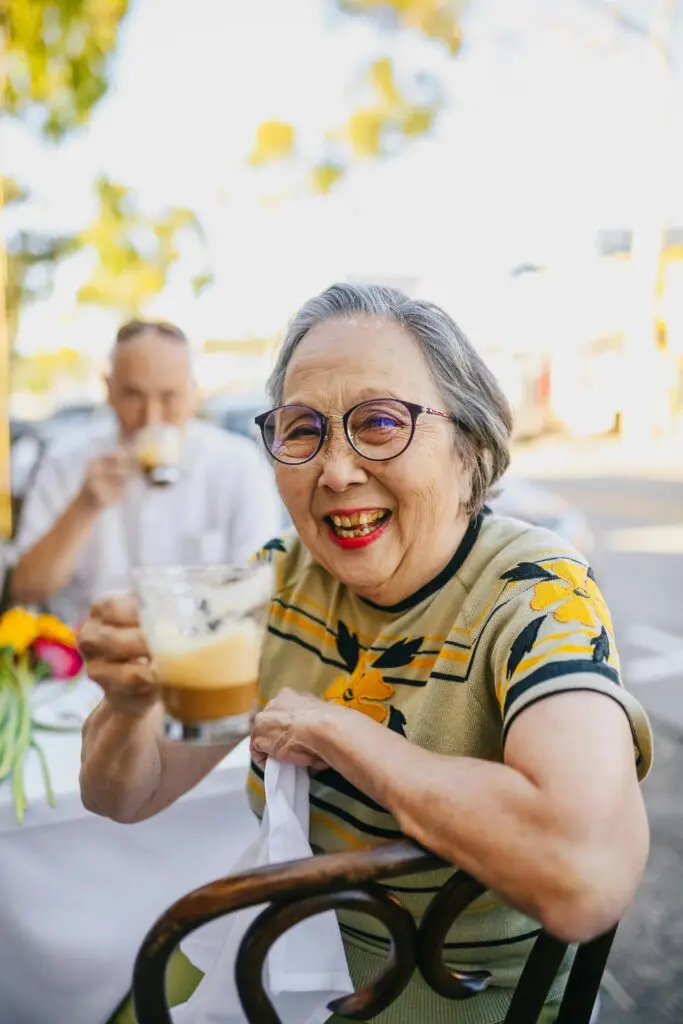 Lady smiling and holding a cup of tea