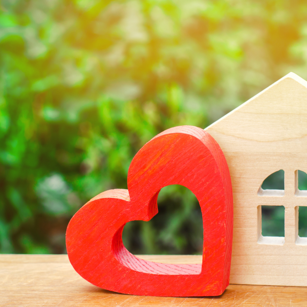 small images of a wooden hear attached to the side of a a wooden house 