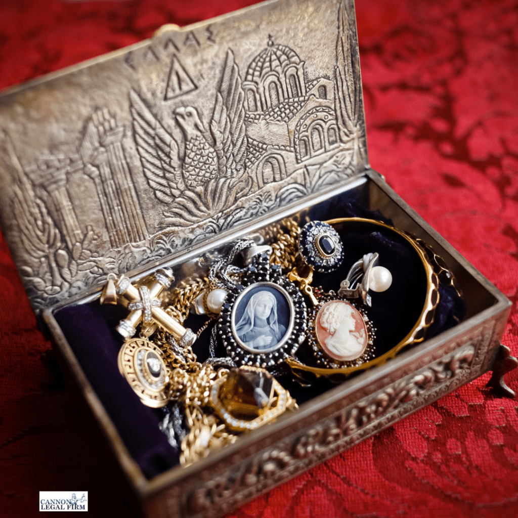 Picture of a jewelry box filed with antique jewelry. 