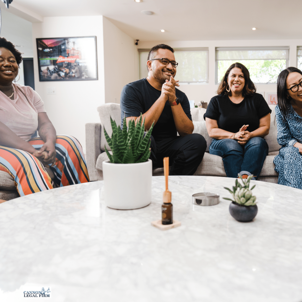 Picture of multiracial adults sitting around a table. 