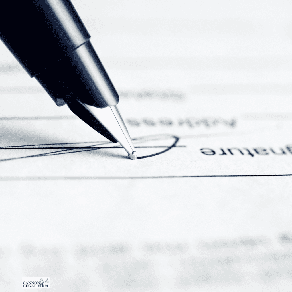 Close up of a pen signing a legal document.