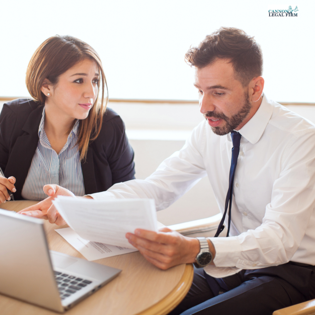 couple sitting at a table, reading paperwork 