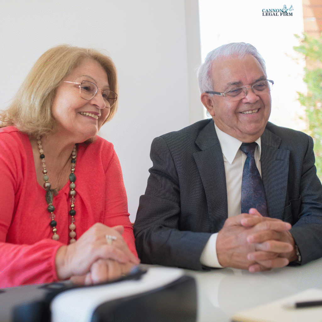 elder man and woman sitting at a table and smiling