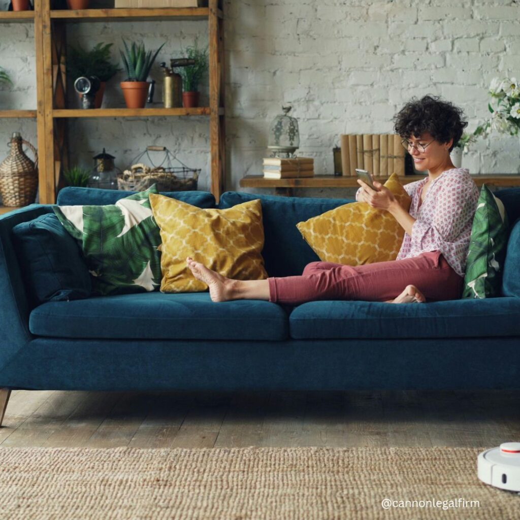 Estate Plan Now for Peace of Mind. Lady sitting on a couch, looking at cell phone and smiling