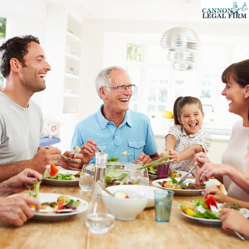 Family gathered around a table, eating, and smiling