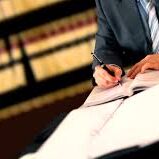 man signing documents